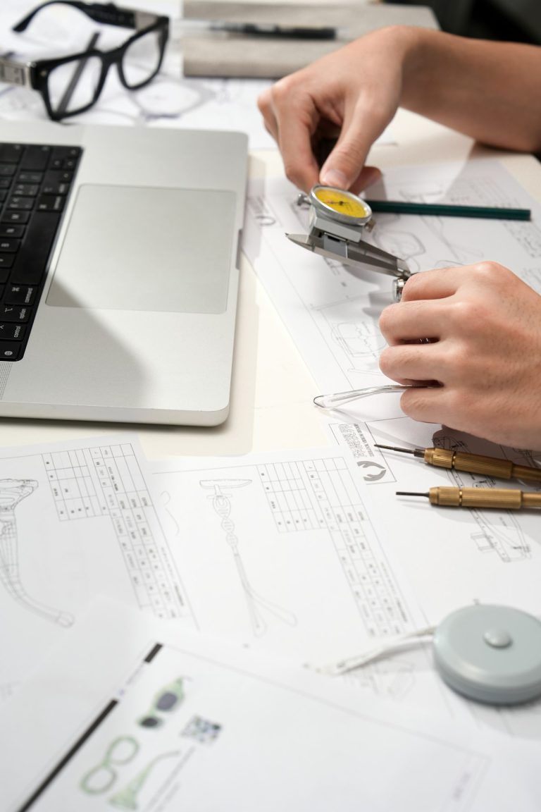 Engineer checking a technical drawing with a caliper