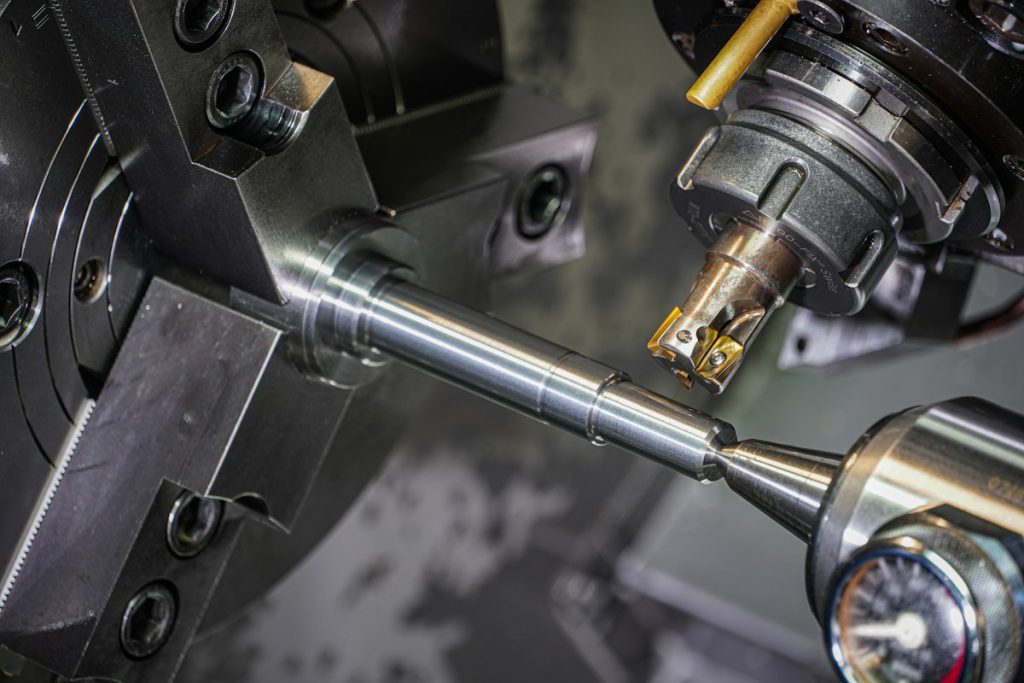 CNC lathe turning a steel shaft